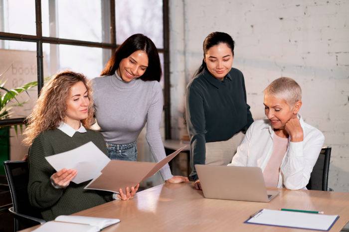 Une réunion entre femmes autour de la table, symbolisant la prise de conscience et la mobilisation pour faire face aux défis de la retraite féminine. 